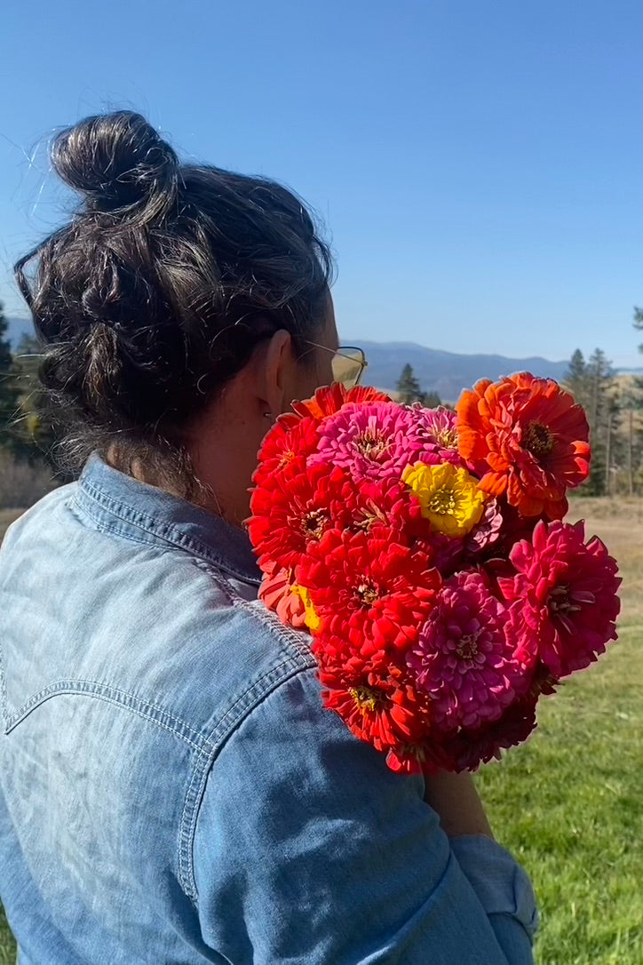 Andrea holding a bundle of zinnias